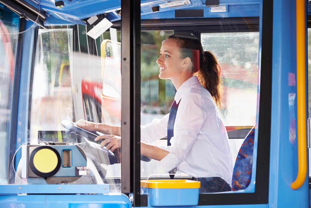 Female Bus Driver Behind Wheel